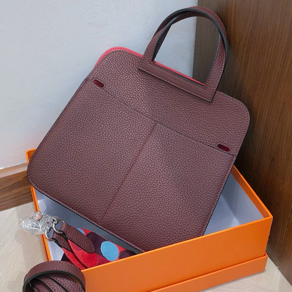 Dual-Tone Burgundy Red Trapezoidal Flap Bag With Integrated Loop Handle, Metallic Buckle Fastener And Slim Matching Shoulder Strap