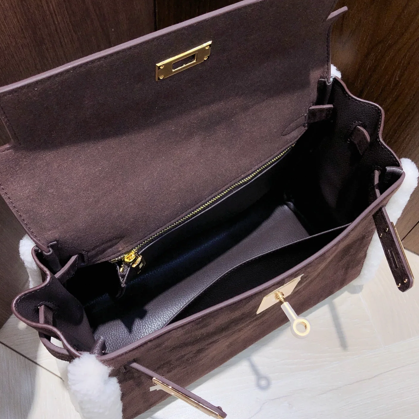 Dark Chocolate Suede Structured Top Handle Bag With White Fluffy Side Trim, Polished Golden Twist Hardware And Spacious Zipper-Lined Interior