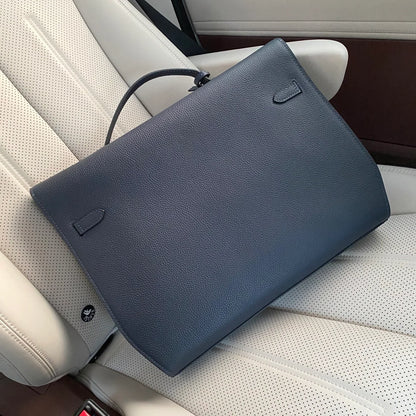 Prussian Blue Elongated Document Hand Bag With Pebble Grain Surface, Silvery Twist Lock Hardware And Slim Curved Top Grip Handle