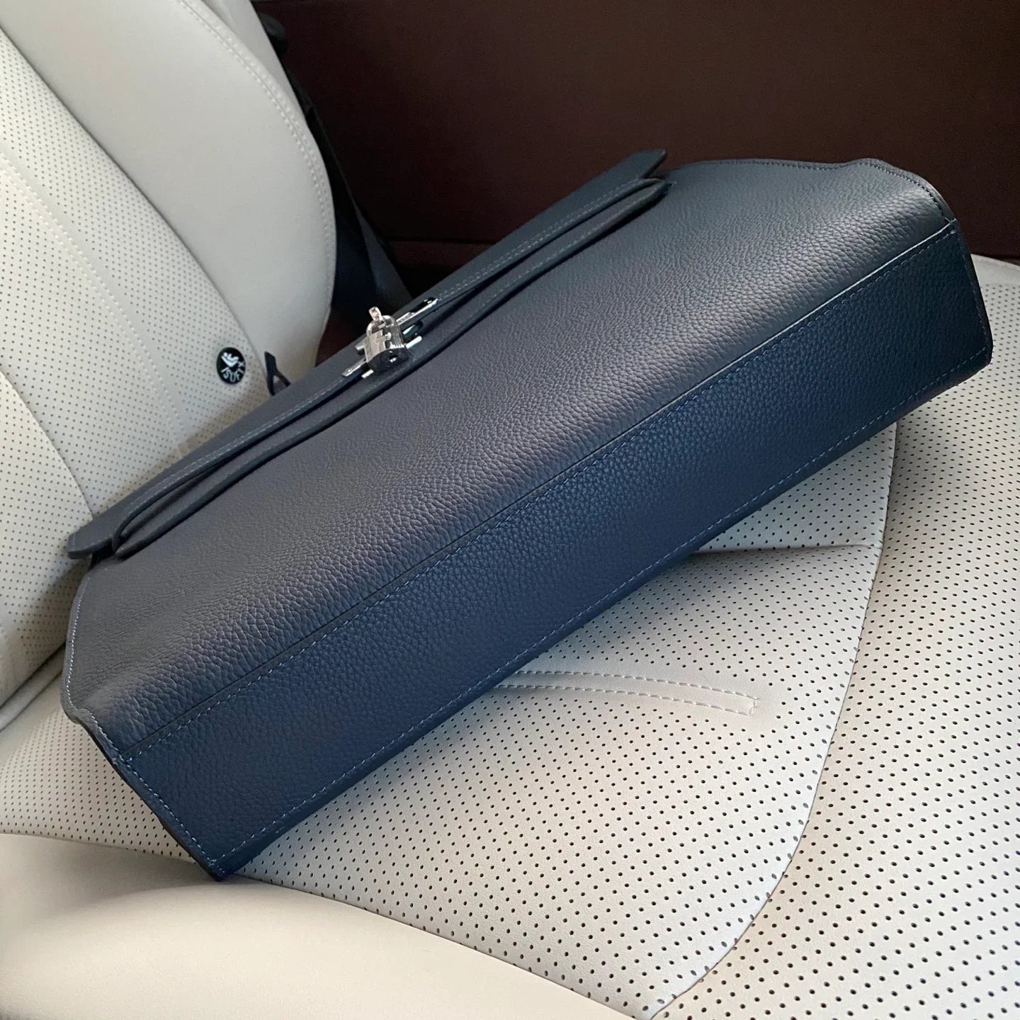 Prussian Blue Elongated Document Hand Bag With Pebble Grain Surface, Silvery Twist Lock Hardware And Slim Curved Top Grip Handle
