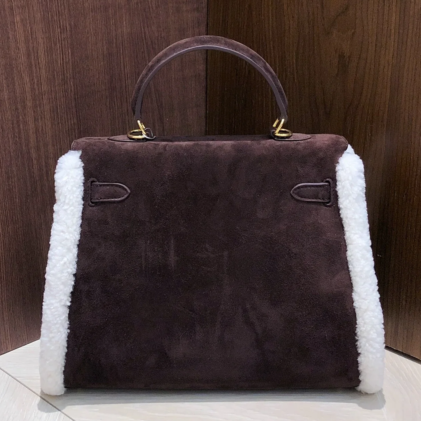 Dark Chocolate Suede Structured Top Handle Bag With White Fluffy Side Trim, Polished Golden Twist Hardware And Spacious Zipper-Lined Interior