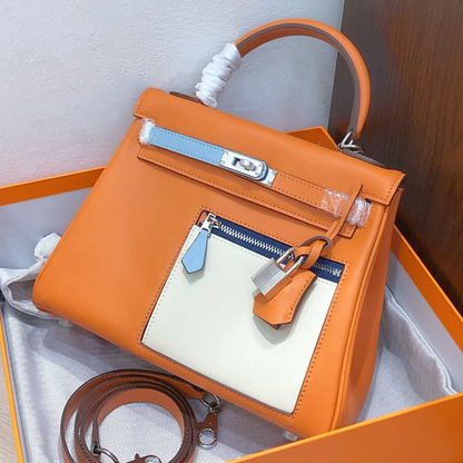 Vibrant Orange Color Block Structured Top Handle Bag With Multi-Tone Accent Panels, Silvery Twist Hardware And Matching Slim Shoulder Strap
