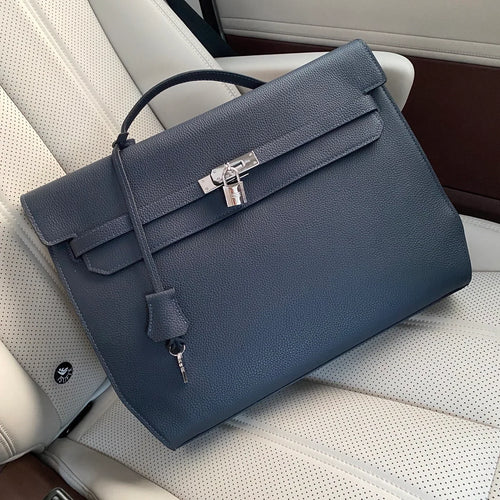 Prussian Blue Elongated Document Hand Bag With Pebble Grain Surface, Silvery Twist Lock Hardware And Slim Curved Top Grip Handle